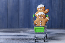 Gingerbread Cookies With Shopping Cart On Wooden Background