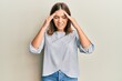© Krakenimages.com - Young beautiful woman wearing casual clothes with hand on head, headache because stress. suffering migraine.