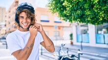 Young Hispanic Man Smiling Happy Wearing Moto Helmet Over Motorcycle At The City