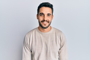 Young hispanic man wearing casual clothes with a happy and cool smile on face. lucky person.