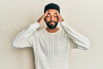 Canvas Print - Handsome hispanic man with beard wearing casual winter sweater with hand on head, headache because stress. suffering migraine.