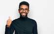 © Krakenimages.com - Young african american man wearing casual clothes smiling happy and positive, thumb up doing excellent and approval sign