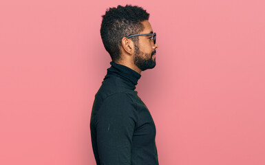 Poster - Young african american man wearing casual clothes looking to side, relax profile pose with natural face with confident smile.