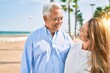 © Krakenimages.com - Middle age hispanic couple smiling happy hugging at the promenade.