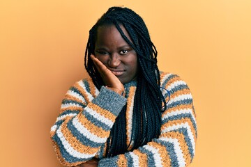 Sticker - Young black woman with braids wearing casual winter sweater thinking looking tired and bored with depression problems with crossed arms.