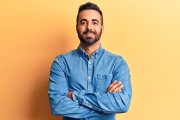 Young hispanic man wearing casual clothes happy face smiling with crossed arms looking at the camera. positive person.