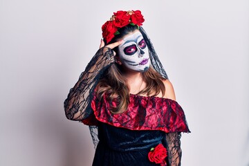 Poster - Young woman wearing day of the dead costume over white pointing unhappy to pimple on forehead, ugly infection of blackhead. acne and skin problem