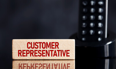 Wall Mural - The word customer representative on wooden block with telephone background. Business concept.