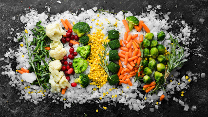 Wall Mural - Assortment of frozen vegetables on ice. Stocks of food. Top view. Free space for your text.