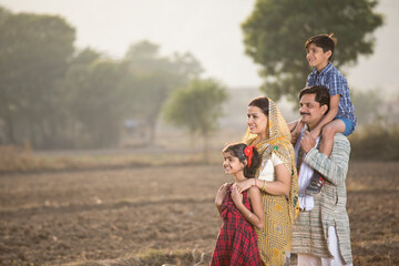 Wall Mural - Happy rural Indian family on agricultural field