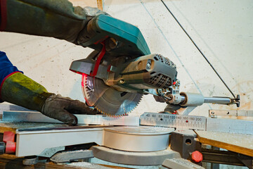 Poster - Metalworking concept. The turner works on the machine. A worker cuts metal on a machine. Hands in work gloves move a sheet of metal to the metal cutting machine.