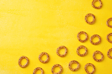 round drying bagels on a yellow background