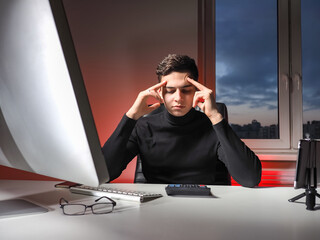 Poster - The businessman looks at the calculator and thinks. Problems in business. The young man business is losing money. Losses of a young businessman. Saving the business.
