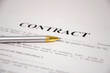 © Valiantsina - the pen is on the contract and the contract is on a white background