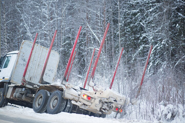 Wall Mural - A logging truck on ice went into a ditch. Accident on the road in winter.