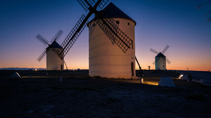 Exterior view of windmills on landscape in spring in Campo de Criptana at sunrise, Ciudad Real, Spain