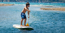Young Boy Stand Up Paddling