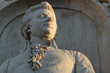 Stone figure of musical genius, composer Wolfgang Amadeus Mozart, in a monument from 1898, closeup horizontal view.