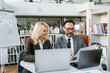 © Kateryna - Business partnership. Focused business partners are sitting at work desk, looking at financial graphs. Successful employees discussing about idea for new project