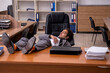 © Elnur - Young male employee sleeping at workplace