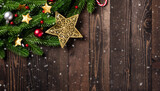 Fototapeta Na ścianę - Christmas holiday garland border, Top view flat lay of tree fir branches, and Xmas ornament bauble decor and the stars on black table wood background with copy space, Happy new year day concept