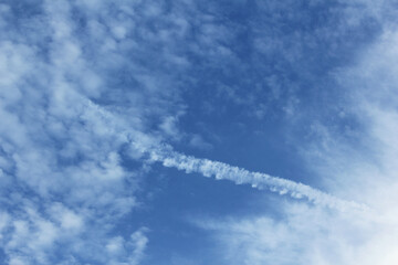 Canvas Print - closeup of chemtrail on blue sky background