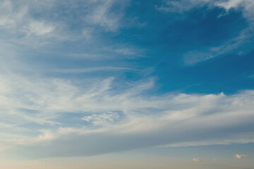 Wall Mural - pretty white clouds stretched by the wind in the blue sky