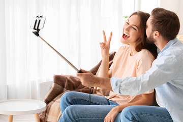 Poster - Young couple taking selfie at home