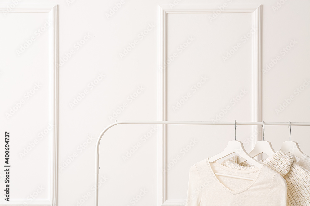 Rack with clothes on white background