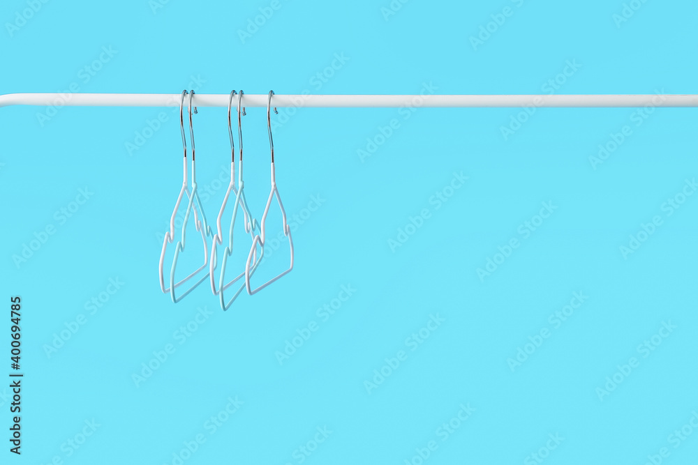 Rack with clothes hangers on color background