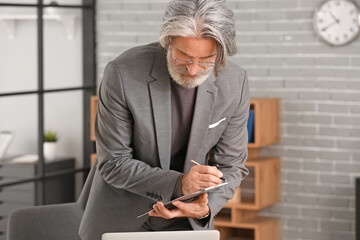 Canvas Print - Senior businessman working in office