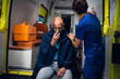 © Anna Kosolapova - Injured man in a blanket is getting first aid in an ambulance car.