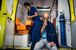 © Anna Kosolapova - Ambulance car, a young nurse is checking her medical kit to provide the first aid to her patient.