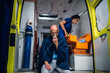 © Anna Kosolapova - Man sits with oxygen mask, nurse in uniform packs equipment in medical bag.