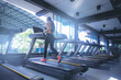 © Panumas - Fit woman running in machine treadmill at fitness gym