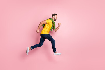 Poster - Full body profile side photo of cheerful young guy run jump empty space sale excited isolated on pink color background