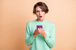 © deagreez - Photo of young attractive woman astonished shocked fake news novelty use cellphone isolated over pastel color background