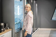 © zinkevych - Blonde female customer choosing a fridge in a megastore