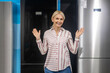 © zinkevych - Blonde woman in striped shirt choosing fridge in a showroom