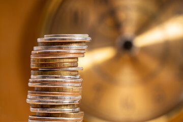 Aufkleber - stack of coins on the background of the clock. money time concept