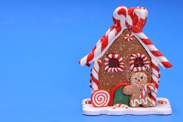 Poster - Christmas toy house with Gingerbread Man on blue background