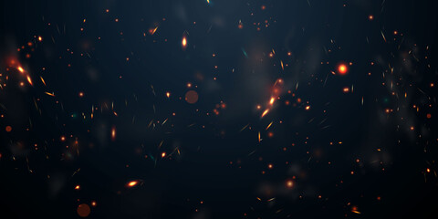 sparks fly up glowing particles on a black background and with flames