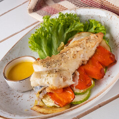 Halibut steak with vegetables on a plate