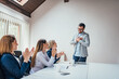 © bnenin - Group of business woman clapping hands to congratulate their charming boss.