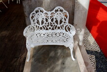 White Carved Metal Bench In A Street Cafe.