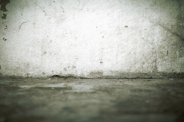 Wall Mural - Old dirty wall with cracks at the junction with the floor, textured background