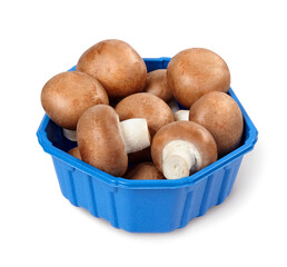 Wall Mural - Champignon mushrooms  in a plastic container isolated on white background. Full depth of field.