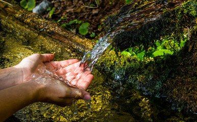 Washing Hands And Drink From A Spring With Clear And Cold Mountain Water