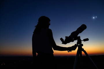 Wall Mural - woman looking at night sky with amateur astronomical telescope.
