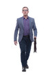 © ASDF - Confident businessman walking with briefcase
